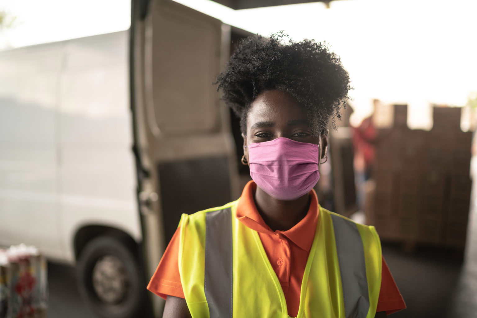 Black woman construction worker with mask